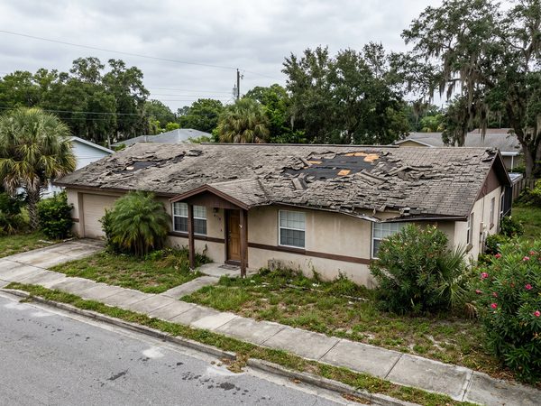 Damaged shingle roof before replacement